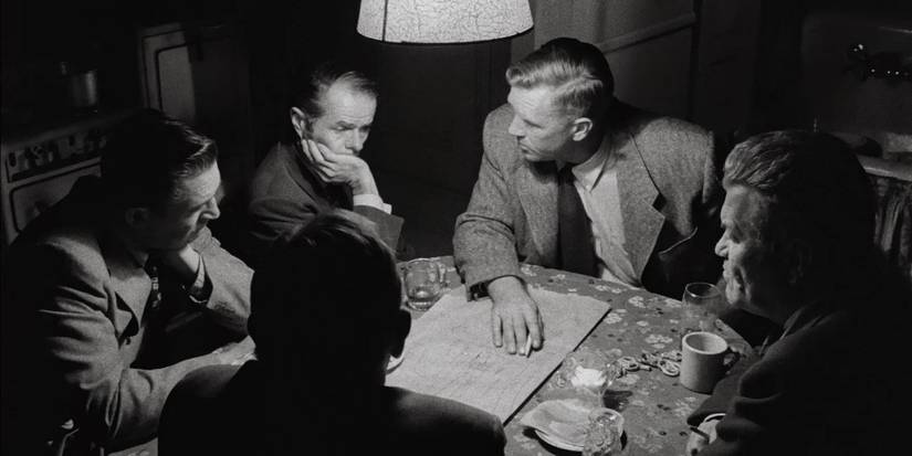 Sterling Hayden sitting with several other men Around a Table in Stanley Kubrick's 'The Killing'