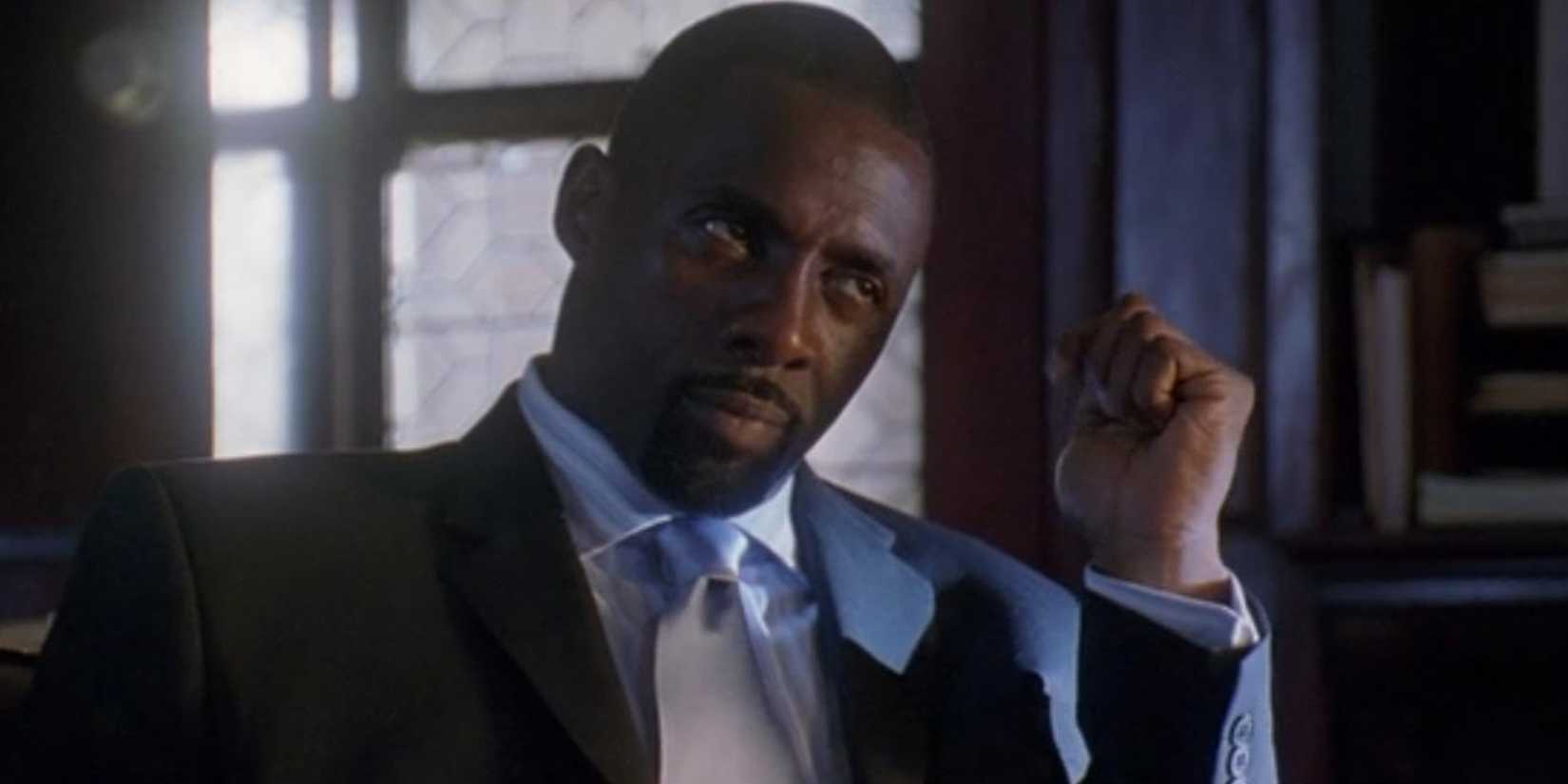 Idris Elba as Stringer Bell seated in a suit in The Wire.