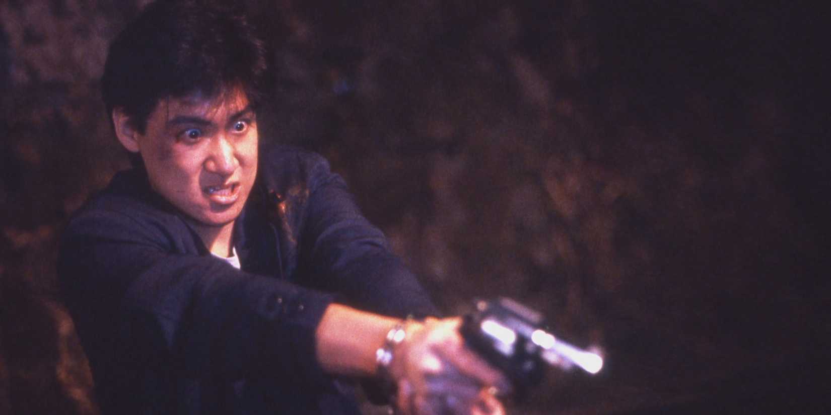 A man aiming a gun in Tiger Cage