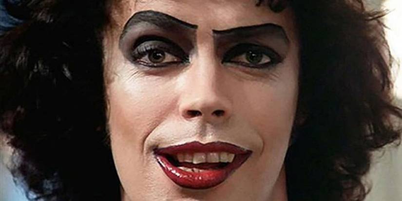 A close-up of Dr. Frank-N-Furter smirking in The Rocky Horror Picture Show