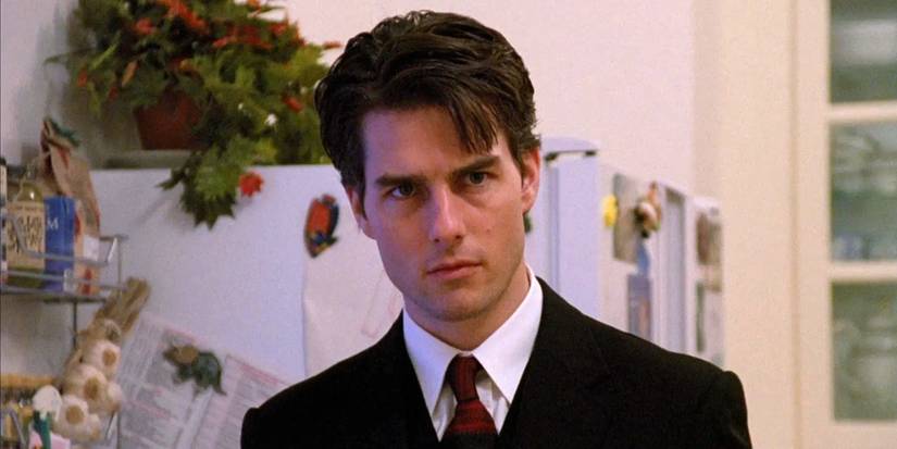 Tom Cruise as Dr. Bill Harford looking somber in a kitchen in 'Eyes Wide Shut'