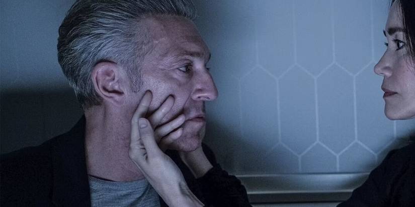 A woman caressing Vincent Cassel's face in 'The Shrouds'