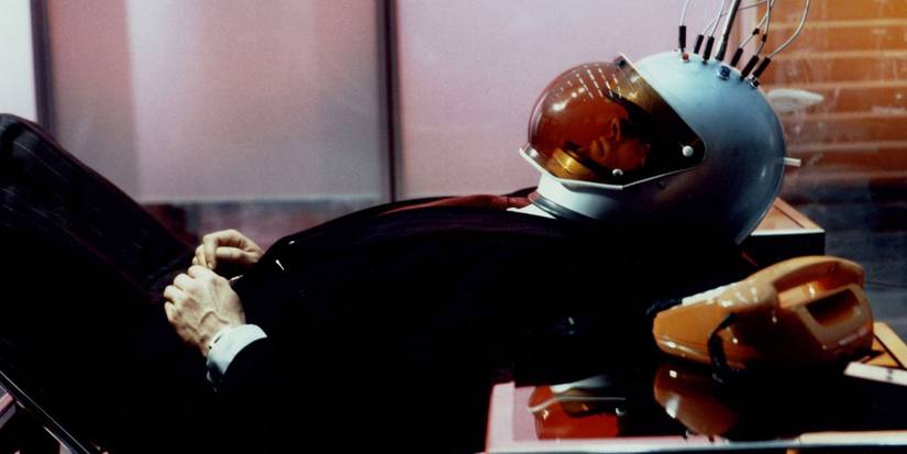 A man wearing a helmet laying down in World on a Wire 1