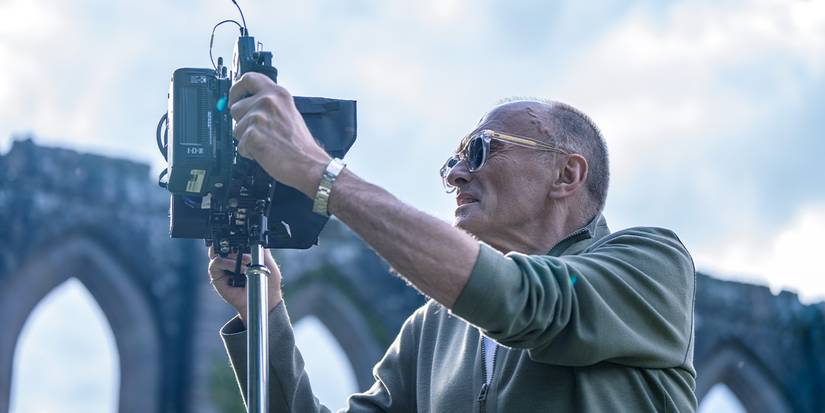 Director Danny Boyle looking through a camera on the set of 28 Years Later.
