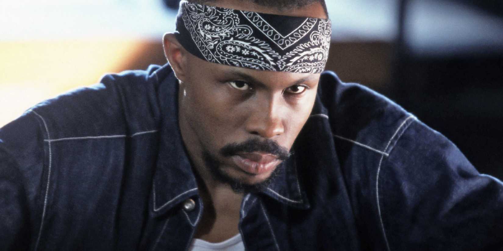 A man with a bandana on his head looking angry in The Wire.