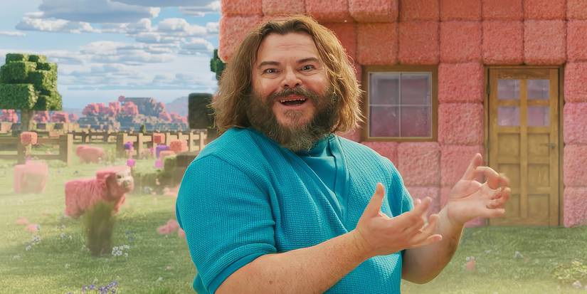 Jack Black as Steve smiling and talking in a field outside a home in A Minecraft Movie