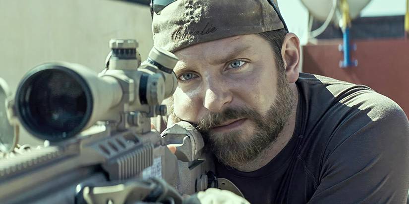 Bradley Cooper as Chris Kyle in military gear taking aim in American Sniper
