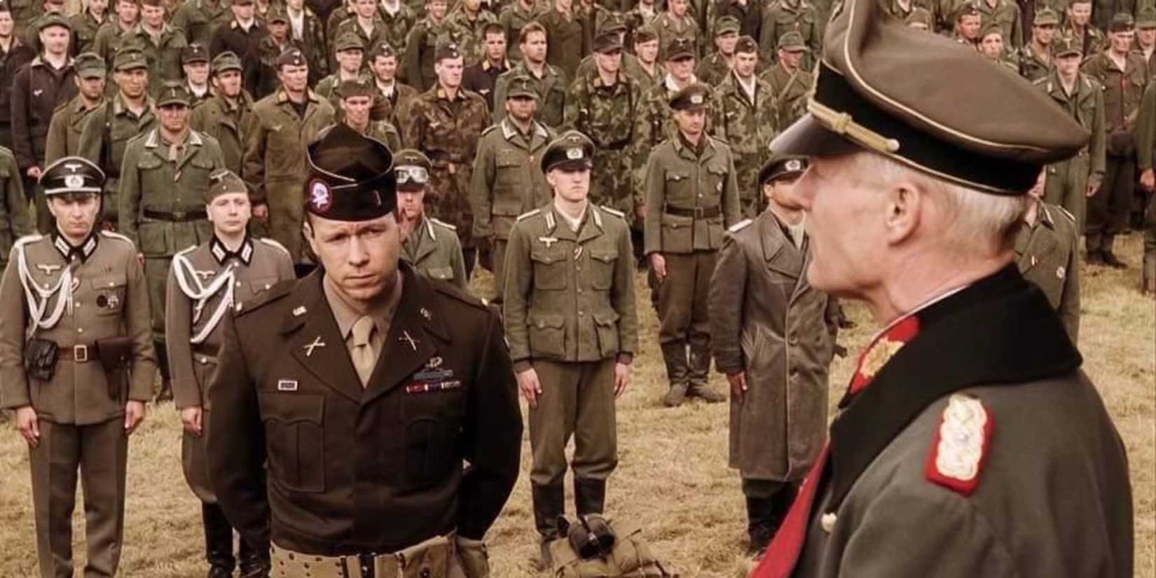 Soldiers in uniform stand at attention at an assembly in the finale of Band of Brothers, Episode 10.