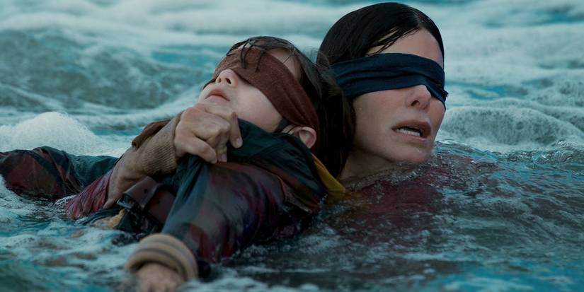 A blindfolded child and woman in the water in 'Bird Box'
