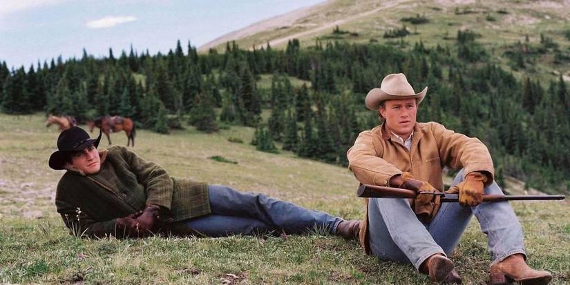 Jake Gyllenhaal and Heath Ledger sit apart on a mountainside in 'Brokeback Mountain'.