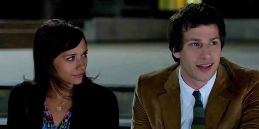 Rashida Jones and Andy Samberg sit next to each other outside a building in Celeste and Jesse Forever.