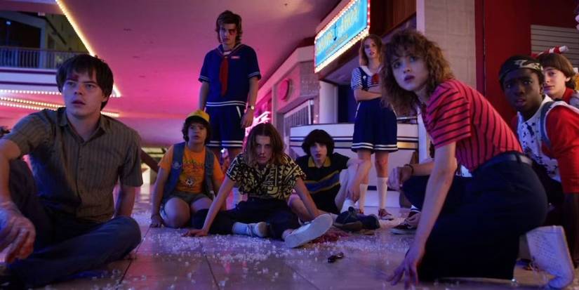 The cast, beaten and tired, huddle together in a mall in Stranger Things episode The Battle of Starcourt.