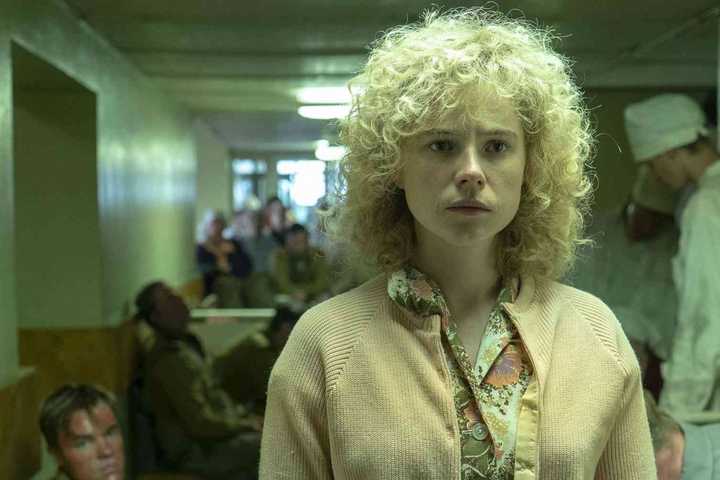 Lyudmilla (Jessie Buckley) walks down a hallway in 'Chernobyl.'