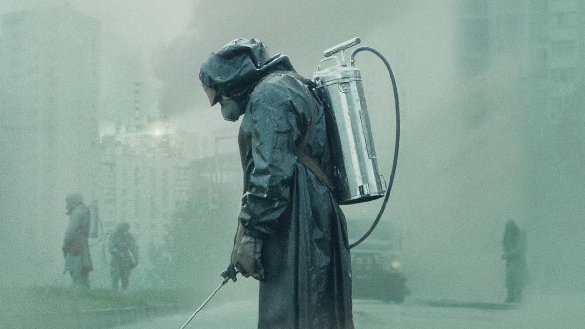 Person in a radioactive suit spraying a chemical in a foggy background in 'Chernobyl.'