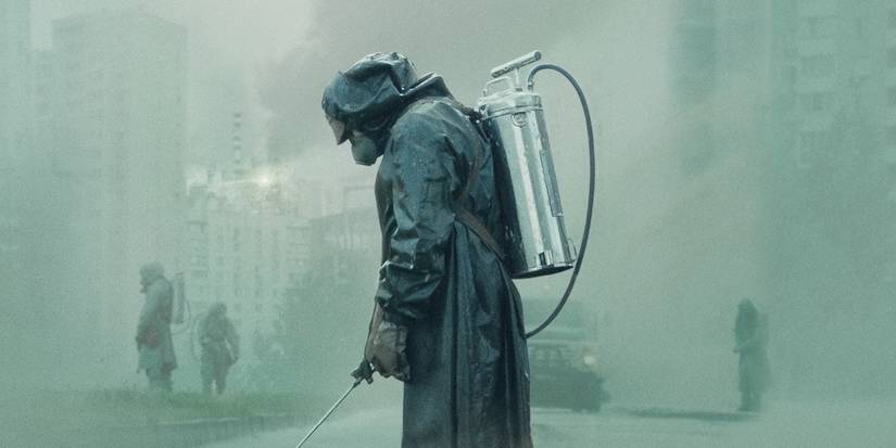 Person in a radioactive suit spraying a chemical in a foggy background in 'Chernobyl.'