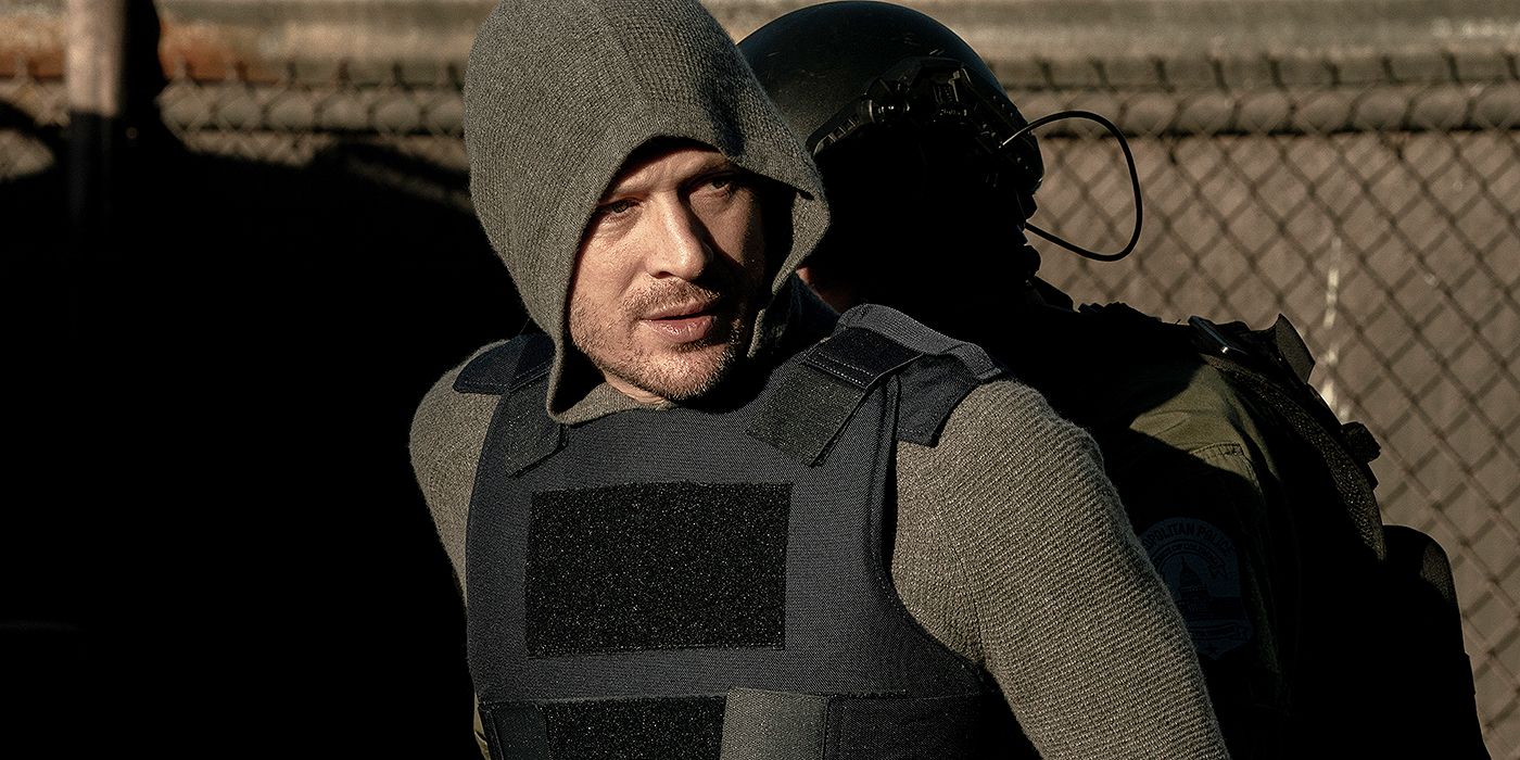 Voit (Zach Gilford) walking with his hood up and in a bullet proof vest while out in the field in Criminal Minds