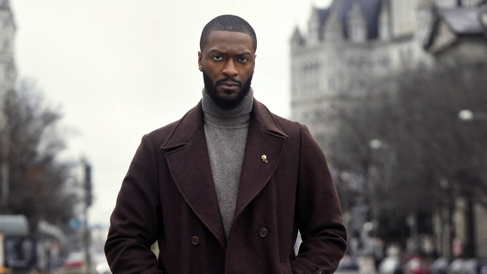 Aldis Hodge as Detective Alex Cross standing outside with his hands in his jacket pockets in Cross Season 1