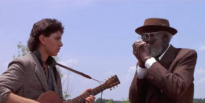 Ralph Macchio as Eddie jaming with Joe Seneca as Willie outdoors in Crossroads.
