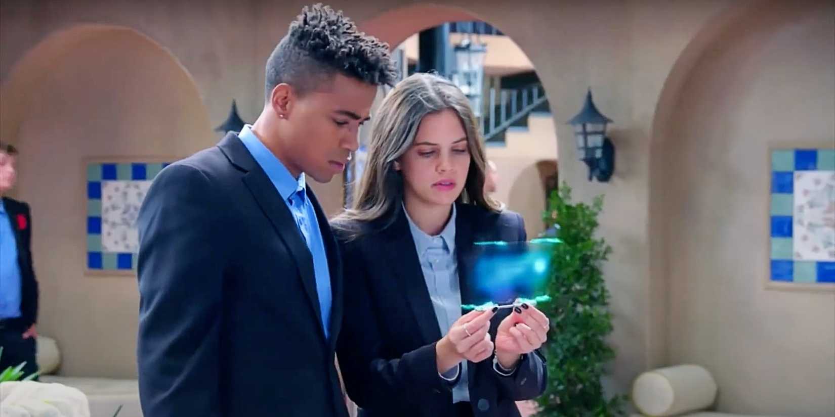 Daniel Hayward and Haley Woods looking at a tablet together in Greenhouse Academy Season 3