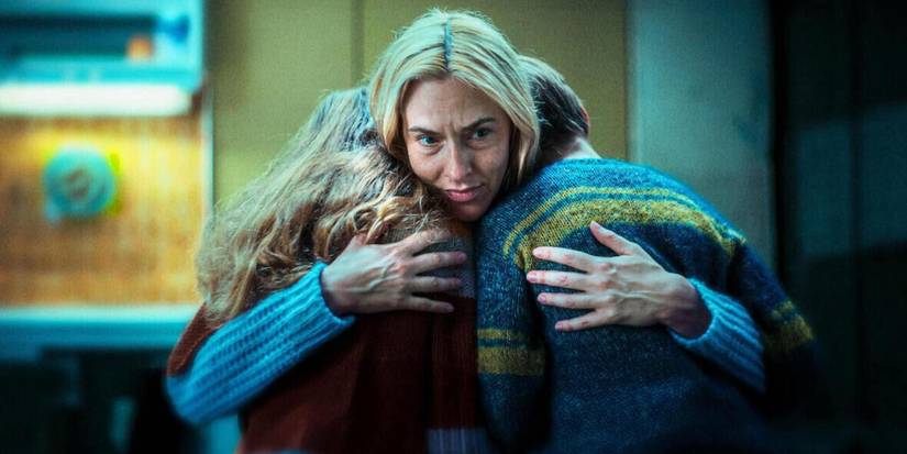 A woman hugging two children in Dear Child