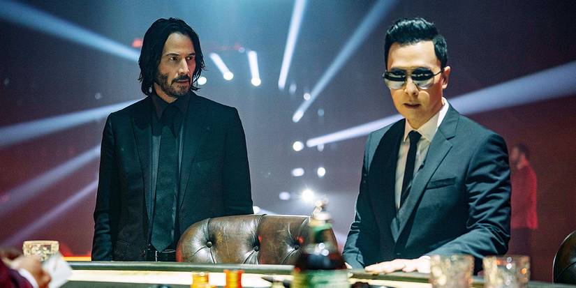 Donnie Yen and Keanu Reeves in front of a desk in John Wick Chapter 4.