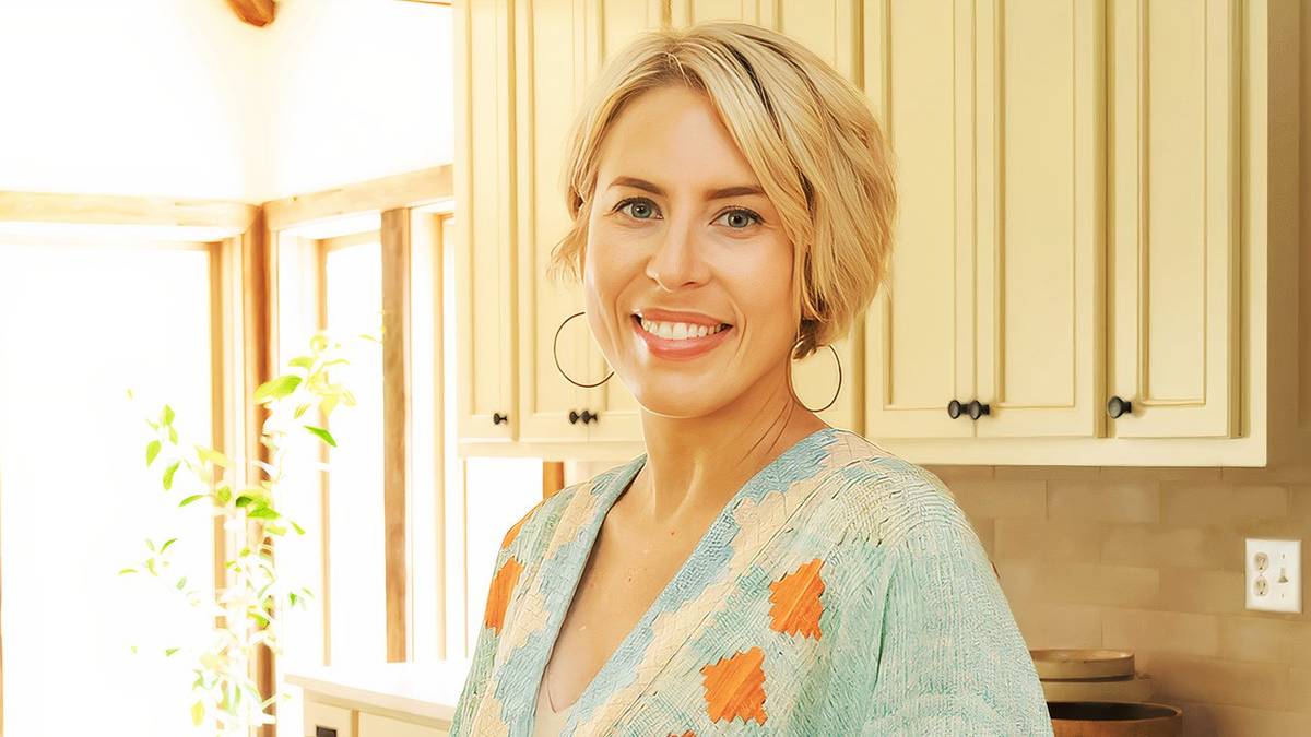 Promotional image of Erin Napier smiling in a warmly lit kitchen