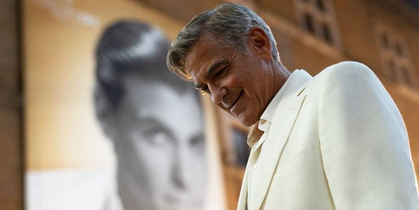 George Clooney as the title role in Jay Kelly, looking down and smiling