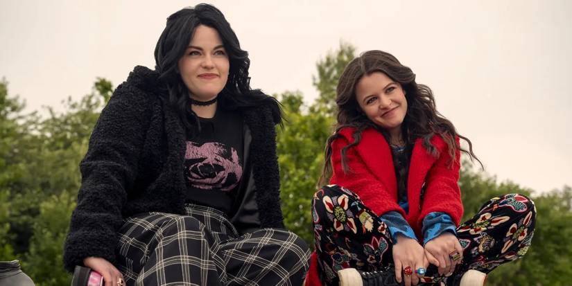 Silver (Katelyn Wells) and Max (Sara Waisglass) sitting next to each other and smiling in Ginny & Georgia Season 3.