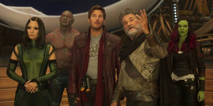 Cast of Guardians of the Galaxy standing side by side looking up.