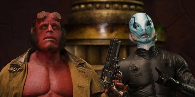 Hellboy (Ron Perlman) standing beside Abe Sapien (Doug Jones) in 2004's Hellboy.