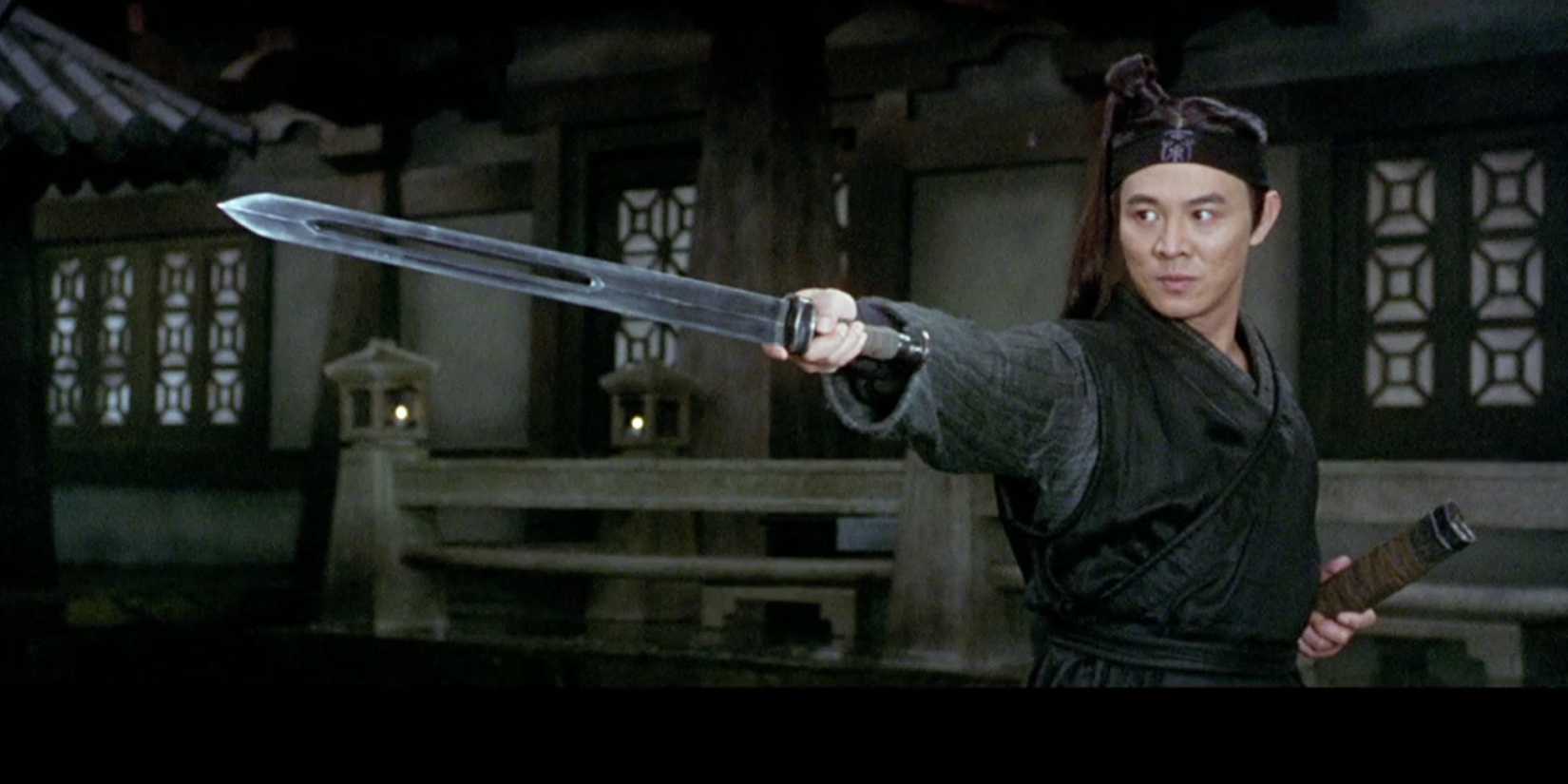 Jet Li holding a sword toward the camera in a still from the martial arts movie Hero (2002)