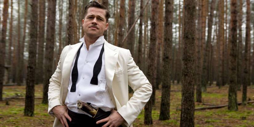 Brad Pitt as Aldo Raine standing in the woods in a disheveled tuxedo in Inglourious Basterds.