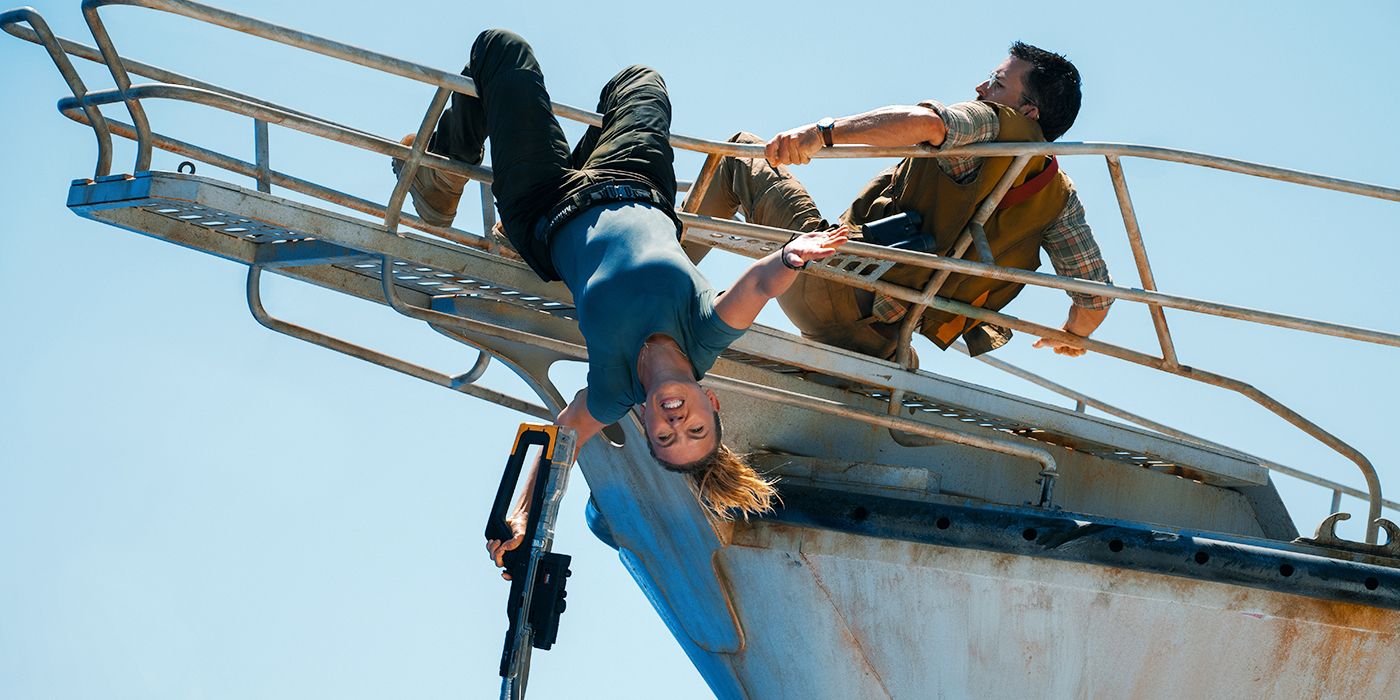 Scarlett Johansson as Zora Bennett, hanging upside down from the pulpit of a boat in Jurassic World Rebirth