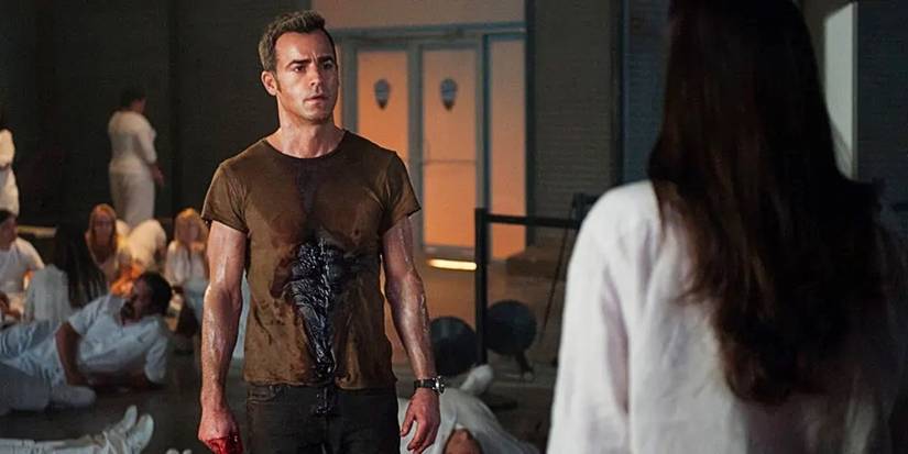 Kevin Garvey bleeds from the chest, surrounded by members of the Guilty Remnant in The Leftovers Season 2.