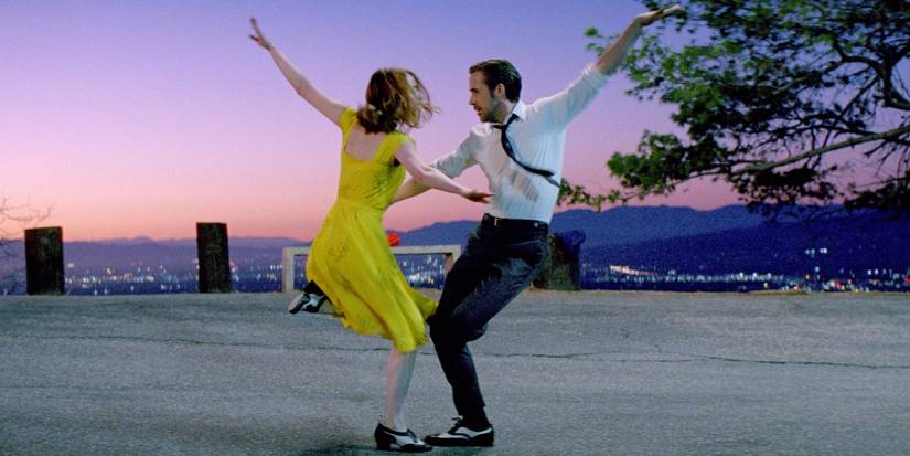 Emma Stone and Ryan Gosling dancing on a street with Los Angeles in the background in La La Land (2016).