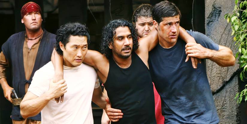 Matthew Fox and Daniel Dae Kim help an injured Naveen Andrews in Lost (2004-2010).