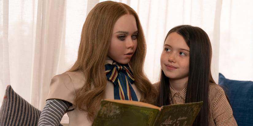 M3GAN reads to Cady, played by actor Violet McGraw, in M3GAN.