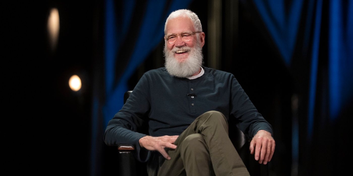 David Letterman duduk di kursi sambil tertawa