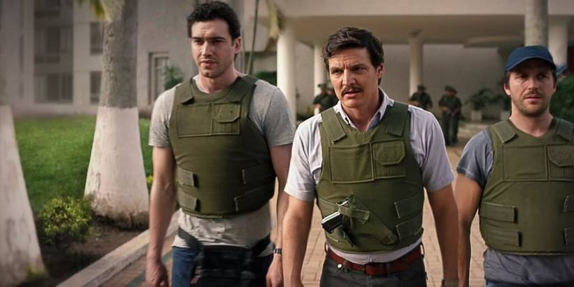 Pedro Pascal as Javier Pena, wearing a bulletproof vest with two agents at his side, in an image from 'Narcos.'