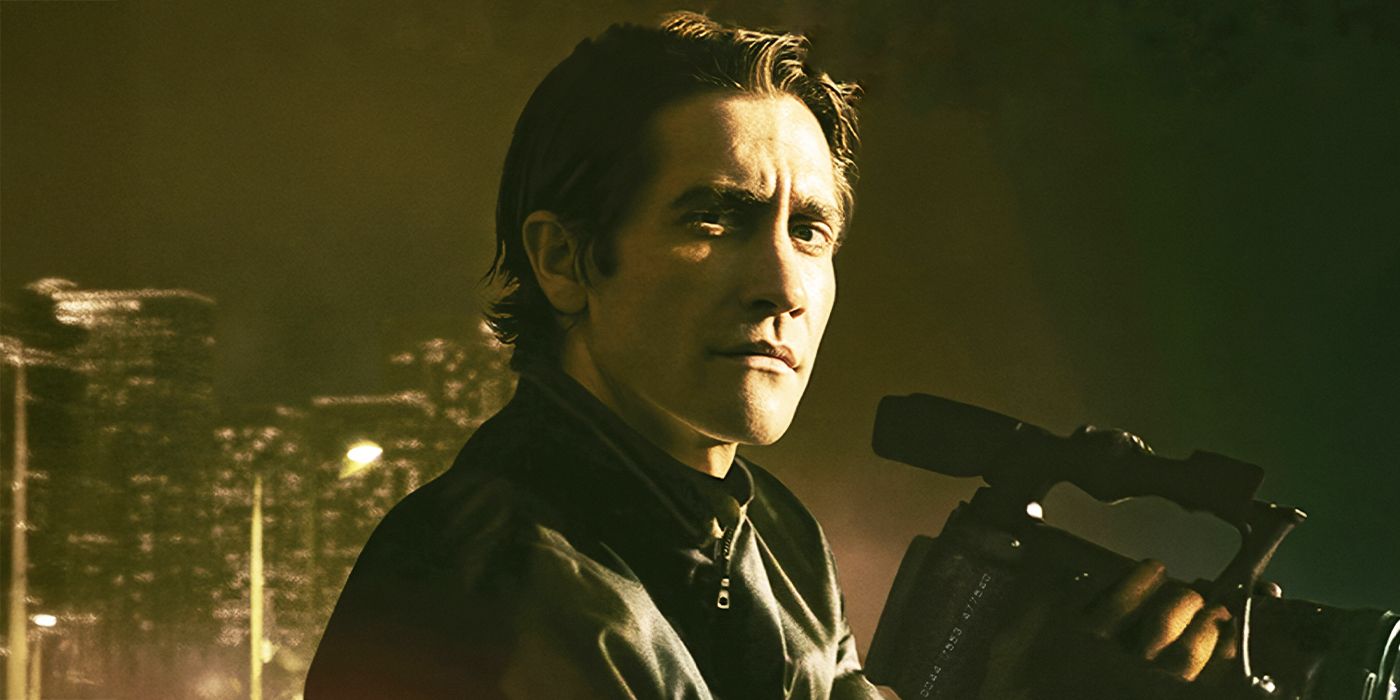 Jake Gyllenhaal holding a camera and looking to his right in Nightcrawler.