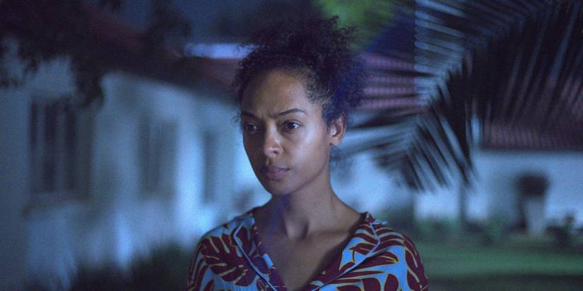 Susan Chardy as Shula standing in the yard in On Becoming a Guinea Fowl 