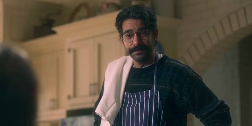 Rahul Kohli as Owen Sharma in a kitchen wearing an apron in The Haunting of Bly Manor.