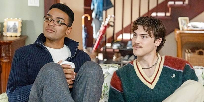 Anton Evans and Paul Baker sitting on the couch together in Adults.