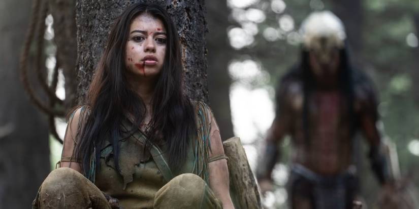 Amber Midthunder as Naru hiding from a Predator in 'Prey'