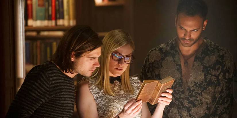 Quentin (Jason Ralph), Alice (Olivia Taylor Dudley), Penny (Arjun Gupta) in a library in The Magicians.