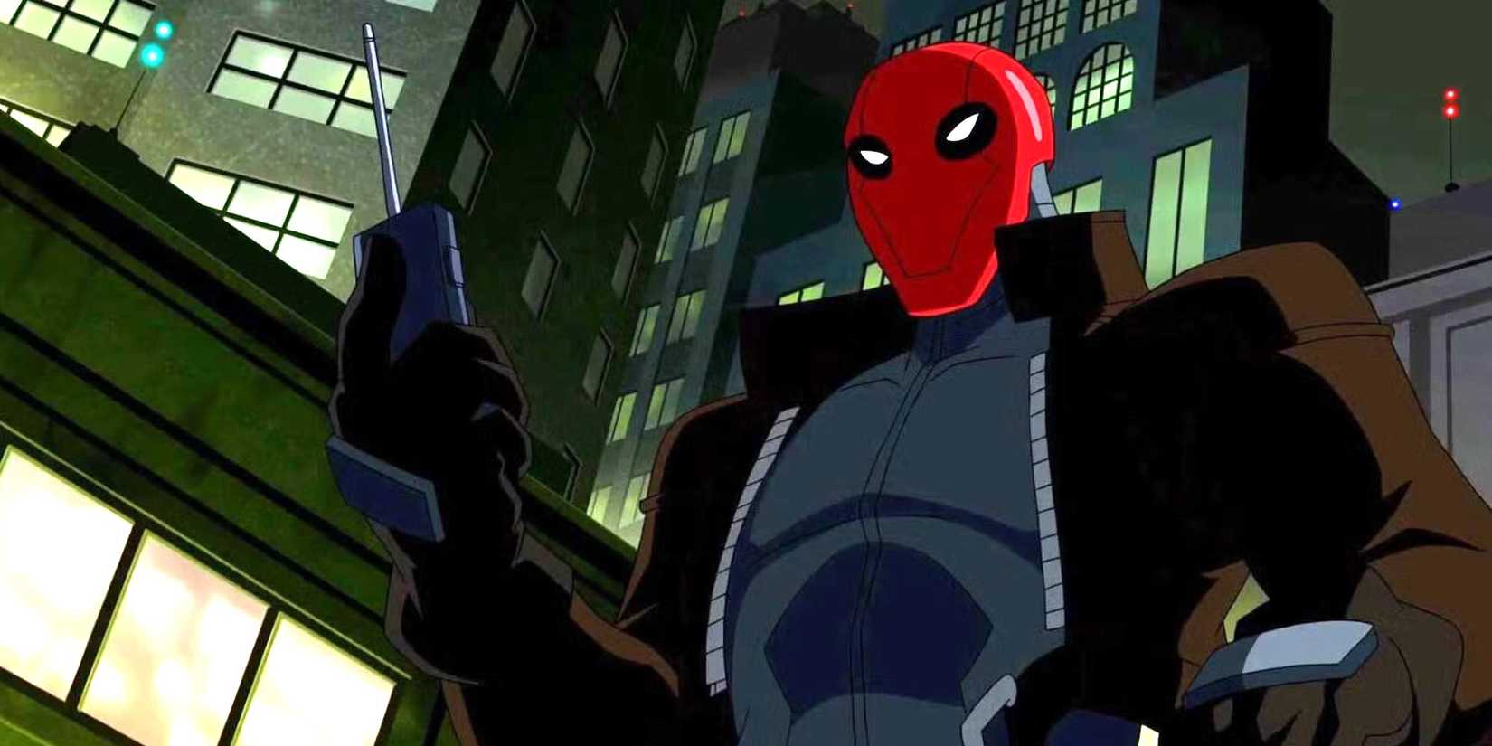 Red Hood holding one of his many gadgets in the animated movie Batman: Under the Red Hood.
