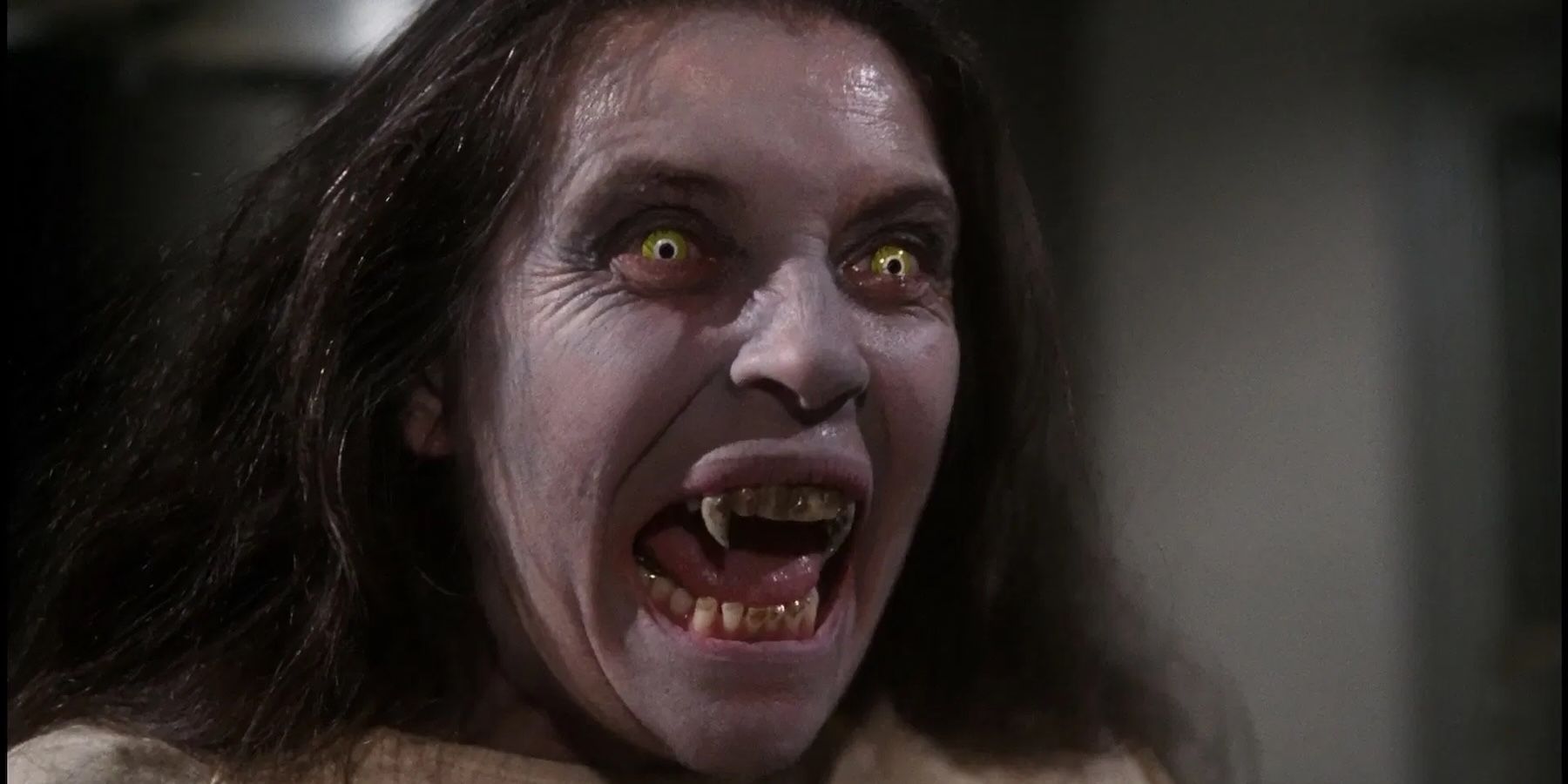 A person with yellow eyes and fanged teeth snarls in Salem's Lot, 1979.