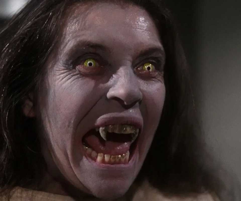 A person with yellow eyes and fanged teeth snarls in Salem's Lot, 1979.