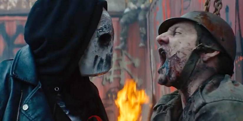 A masked member of the Red Crow Indian Reservation stares at a zombie in Blood Quantum (2019).