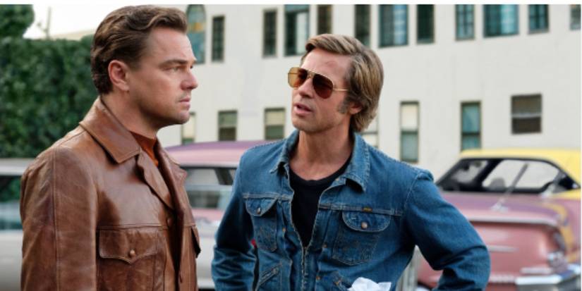 Leonardo DiCaprio and Brad Pitt as Rick Dalton and Cliff Booth wearing a leather jacket and jean jacket in 'Once Upon a Time in Hollywood'